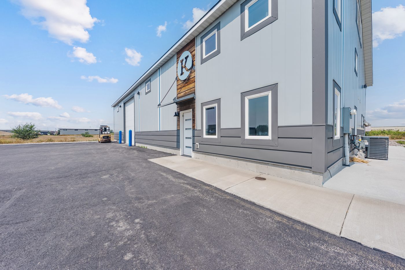 Front entry of 573 Business Loop with signage and office windows