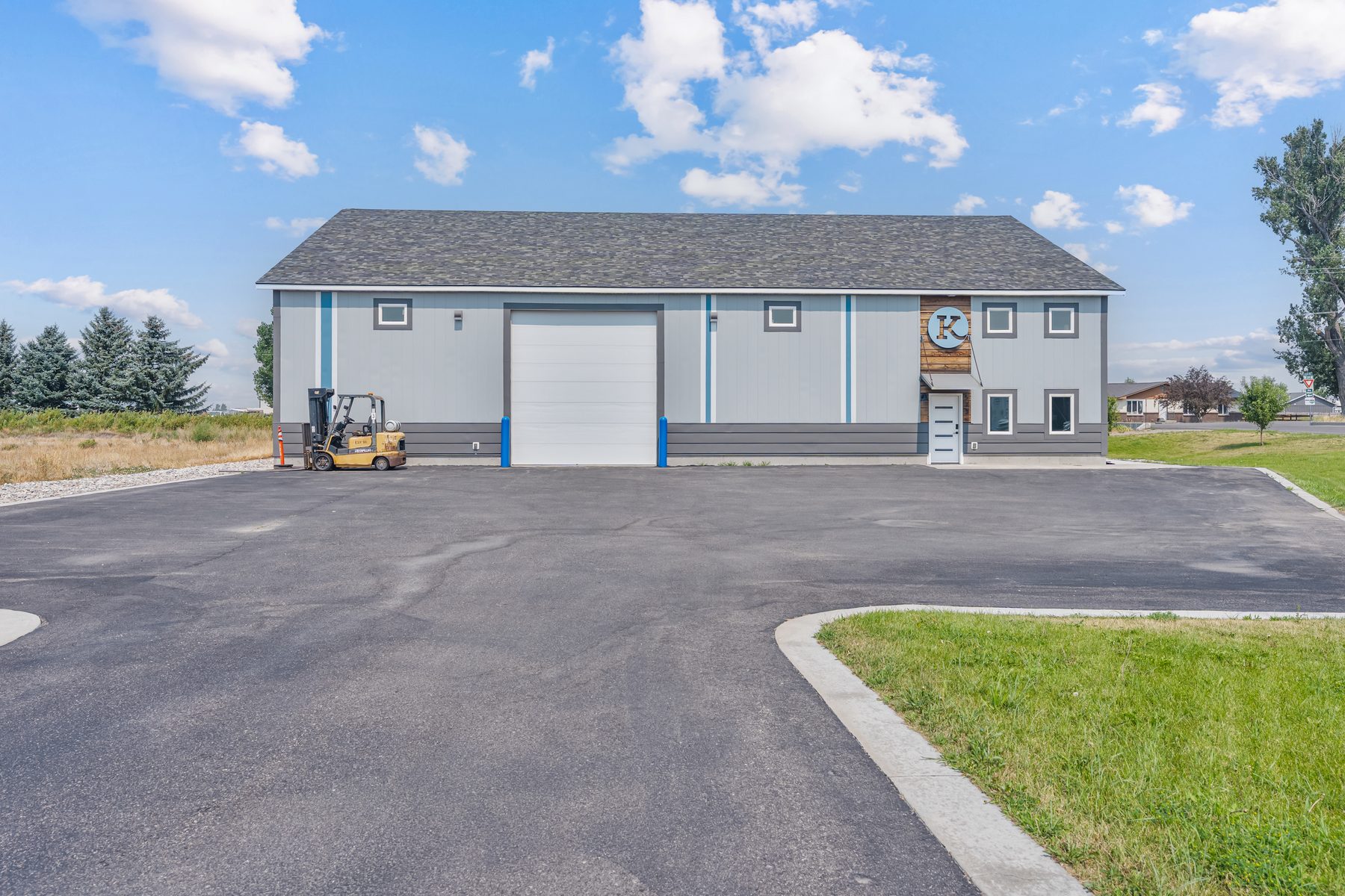 573 Business Loop, a modern commercial building in Sugar City, Idaho with a large overhead door