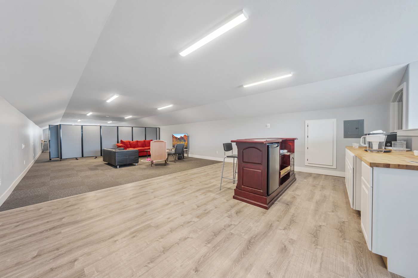Third floor suite with long open workspace and bar