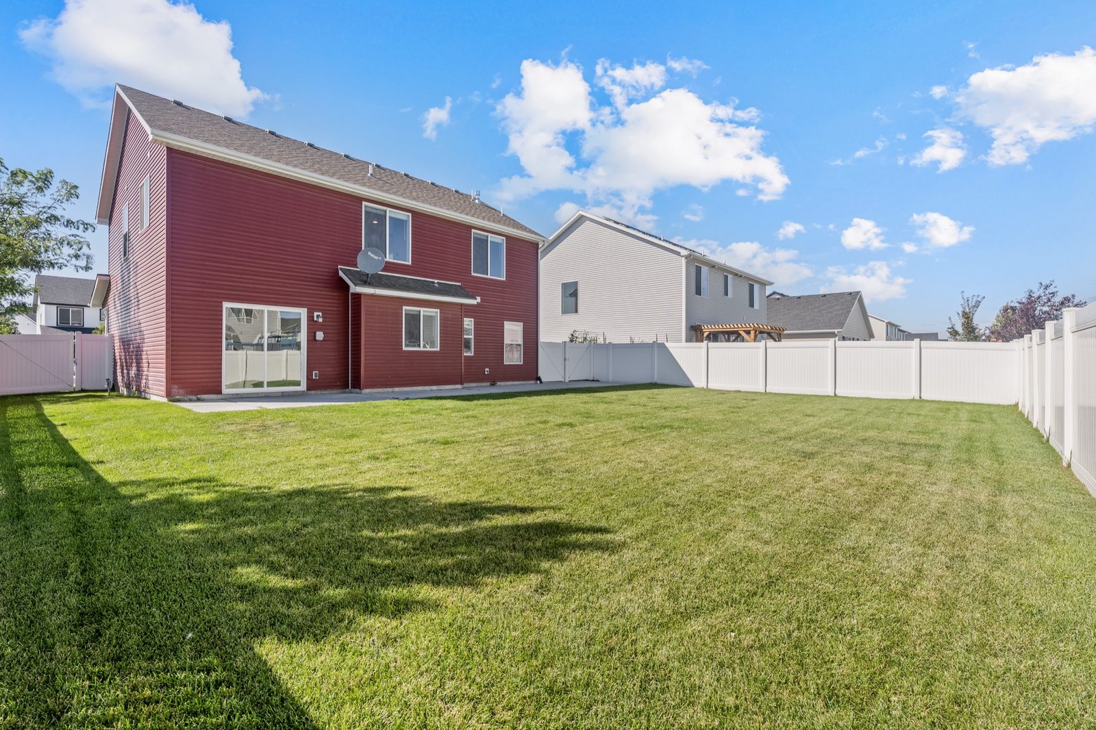 Fenced backyard with lawn