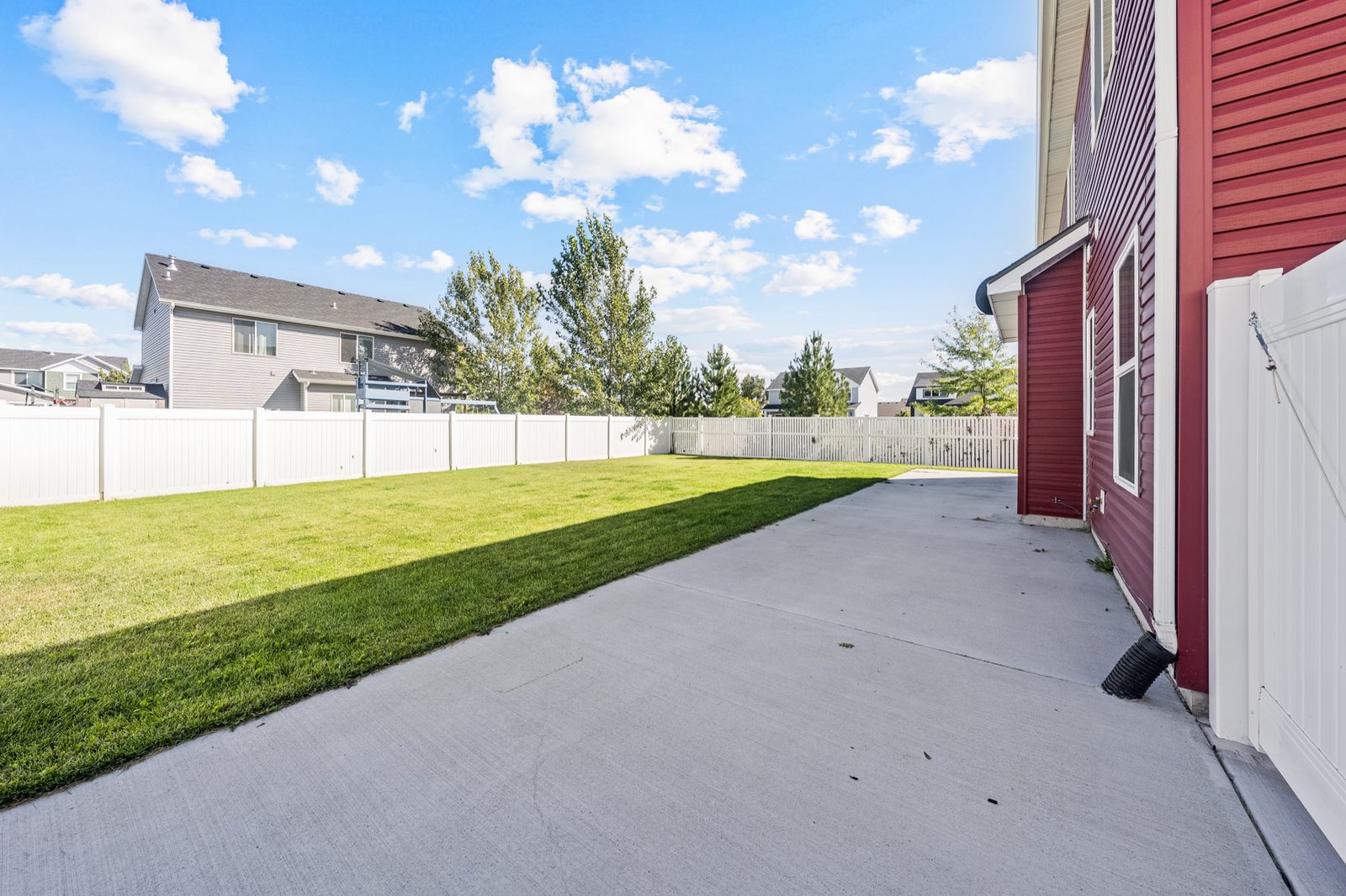 Extended concrete parking pad along the side of the home